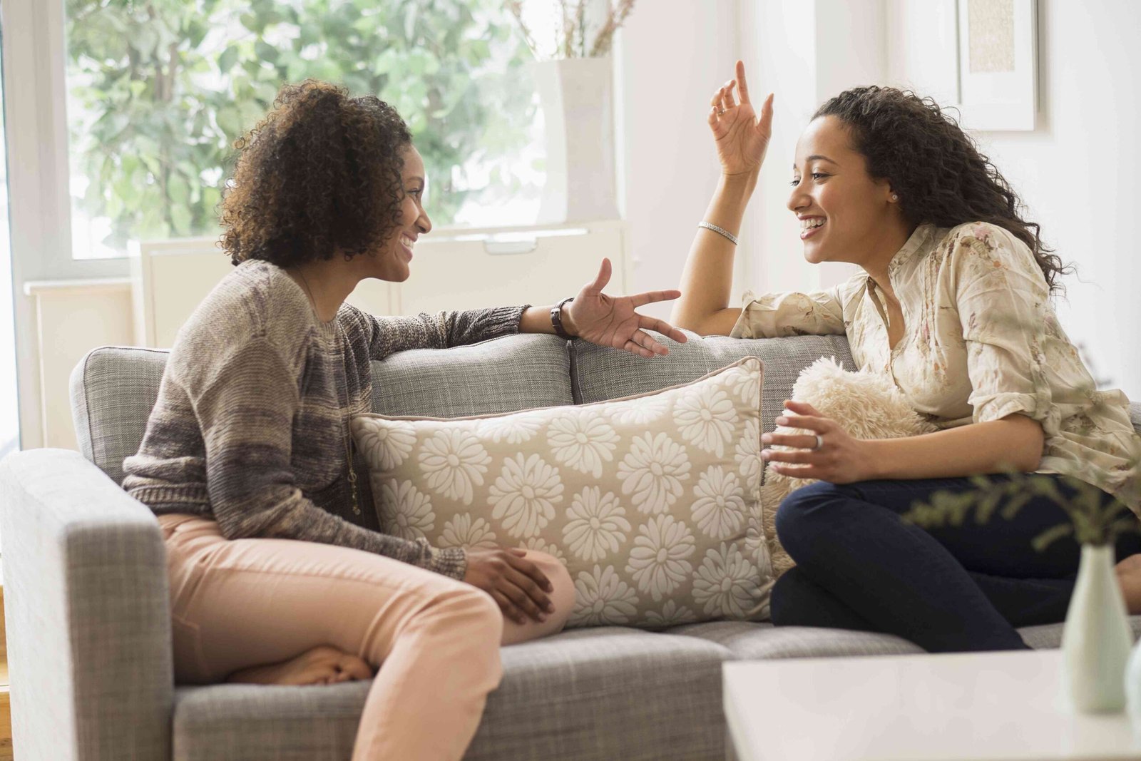 laughing women talking on sofa 557475619 5855ba875f9b586e02be9cdd